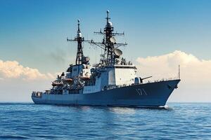 Naval warship sailing on calm waters under a clear sky. photo