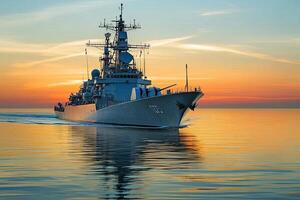 Naval ship sailing at sunset over calm waters. photo