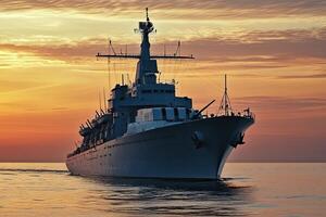 Naval ship navigating through water at sunset. photo