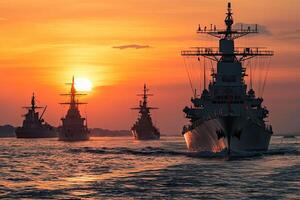 Naval ships silhouetted against a sunset. photo