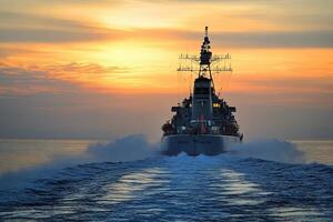 Naval vessel navigating through water at sunset. photo