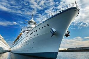 Large cruise ship docked at a harbor under a blue sky. photo