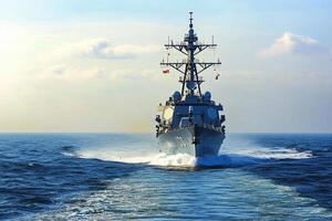 Naval destroyer navigating through ocean waters. photo