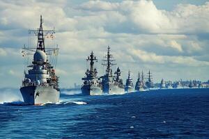 Naval fleet sailing through the ocean under a cloudy sky. photo