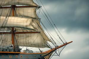 Tall ship with sails against a cloudy sky. photo