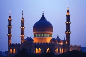 Illuminated mosque at dusk, showcasing its architecture and minarets. photo