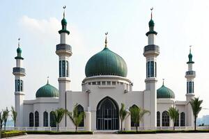 Grand mosque with green domes and minarets under a clear sky. photo