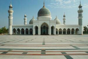 Grand mosque with white walls, blue domes, and minarets on a vast plaza. photo
