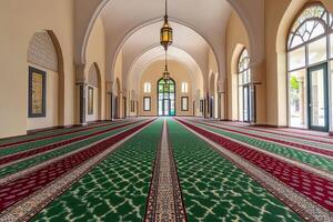 Empty mosque hallway with arched ceilings, patterned carpet, and stained-glass window. photo