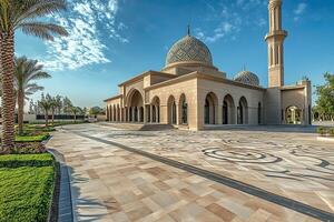 Grand mosque exterior, sunlit courtyard, ornate stonework, blue dome. photo