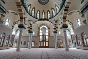 Grand mosque interior, arched columns, stained glass, dome ceiling, prayer hall. photo
