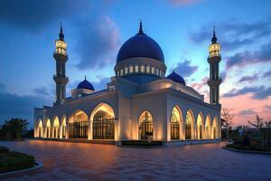 Illuminated mosque at twilight, showcasing architectural details and serene atmosphere. photo