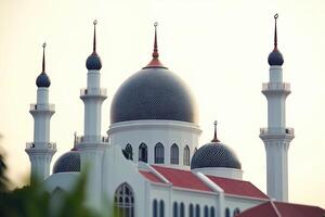 Majestic mosque with multiple domes and minarets against a clear sky. photo