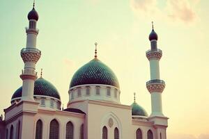 Majestic mosque at sunset, showcasing intricate architecture, domes, and minarets against a serene sky. photo