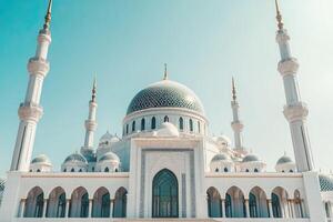 Majestic white mosque under a clear blue sky. photo