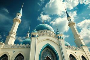 Low angle view of a majestic white and blue mosque against a vibrant blue sky. photo