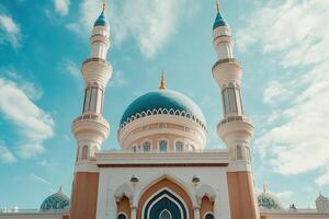 Low angle view of a beautiful blue domed mosque under a bright sky. photo