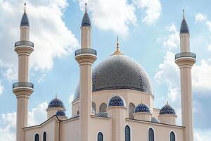 Majestic mosque with four minarets under a bright sky. photo