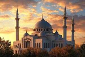 Majestic white mosque at sunset, with trees and minarets. photo