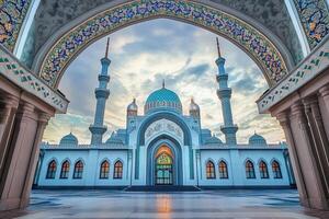 Majestic mosque at sunset, viewed through ornate archway. photo