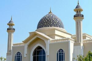 Ornate mosque dome and minarets under clear sky. photo