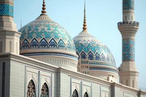 Ornate blue and white mosque domes against a clear sky. photo
