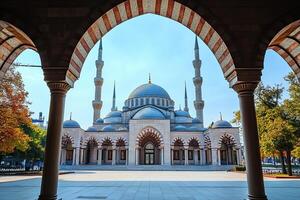 Mosque framed by archway, clear blue sky. photo