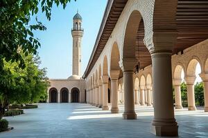 Mosque courtyard with arched colonnade and minaret. photo