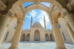 Mosque courtyard with arches framing the building under a blue sky. photo