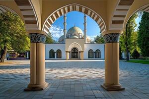 Mosque framed by arched columns in a sunlit courtyard. photo