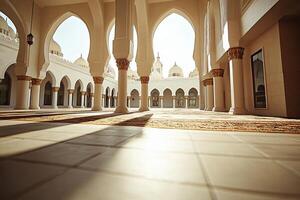 Sunlit mosque courtyard with arches, pillars, and tiled floor. photo
