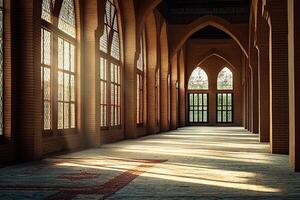 Sunlit mosque interior with arched windows and prayer rugs. photo