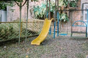 Playground slide and swings in a luxury residential complex photo
