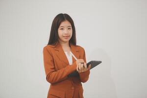 Young beautiful Asian woman in business office standing use tablet in hand, Thai girl enjoy browsing for online shopping store with copy space for advertisement, on isolated white background photo