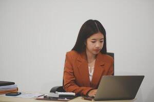A driven and dedicated young professional showcases her efficiency and attention to detail as she works diligently on her laptop photo