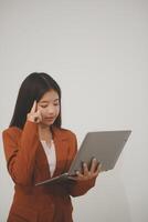 Young beautiful Asian woman in business office standing use tablet in hand, Thai girl enjoy browsing for online shopping store with copy space for advertisement, on isolated white background photo