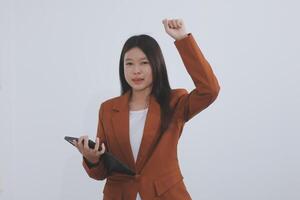 Happy relaxed young woman standing in home office using tablet, excited lady laughing holding tablet, enjoying doing online ecommerce shopping in mobile apps photo