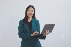 Attractive elegant young asian business woman using digital tablet standing on isolated background. Happy young latin female formal black suit holding tablet gadget working service with customer photo