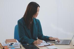 Asian professional businesswoman working on tablet computer in a corporate office photo