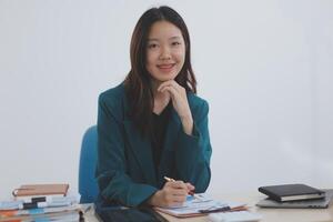 Asian professional businesswoman working on tablet computer in a corporate office photo