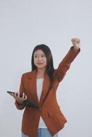 Happy relaxed young woman standing in home office using tablet, excited lady laughing holding tablet, enjoying doing online ecommerce shopping in mobile apps photo