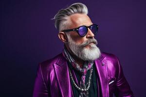60 year old fashionable hipster man portrait on bright purple background photo
