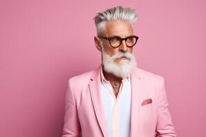 60 year old fashionable hipster man portrait on bright pink background photo