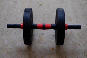 A versatile, adjustable weight barbell ideal for strength training and fitness routines at home or in gyms. photo
