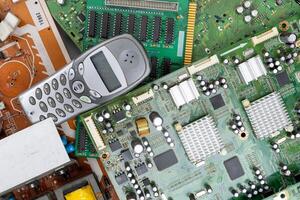 Electronic Waste with Old Mobile Phone and Circuit Boards photo