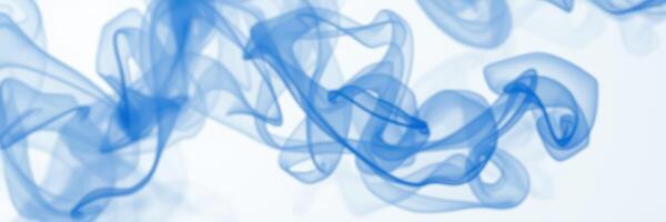 Wisps of blue smoke create an ethereal atmosphere in a minimalistic setting photo