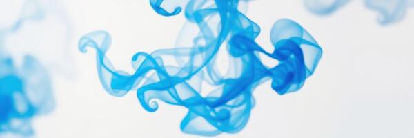 Fluid blue smoke gracefully swirls in the air against a light background, creating an ethereal composition of movement and color photo