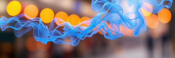 Colorful blue ribbons of fabric flowing through a softly lit space with warm golden bokeh lights in the background during evening hours photo