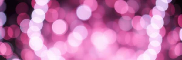 Vibrant bokeh background with pink hues creating a lively and colorful atmosphere at a festive event photo