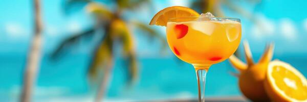 Refreshing tropical cocktail served by the beach with palm trees in the background during a sunny day photo